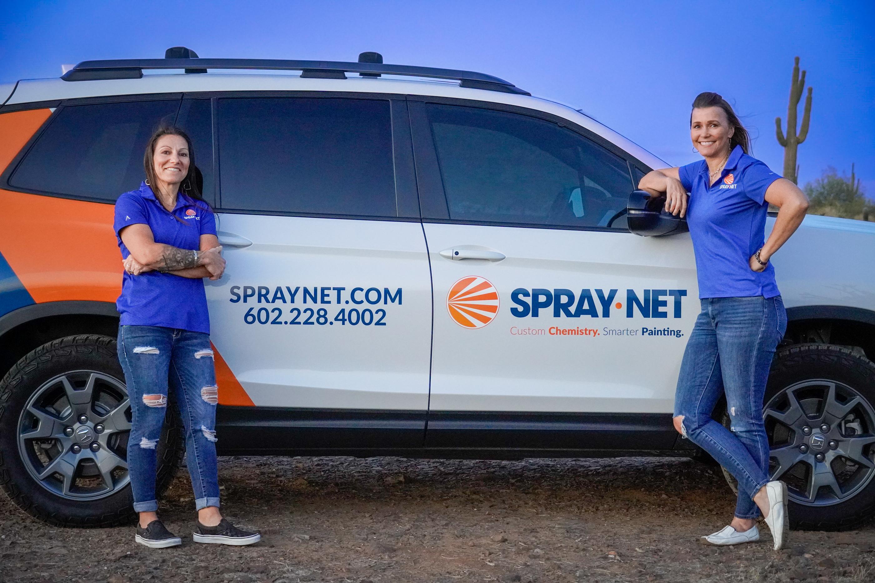 Spray-Net team standing together in front of a company truck.