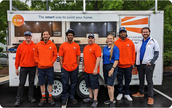 Spray-Net team standing together in front of a company truck.