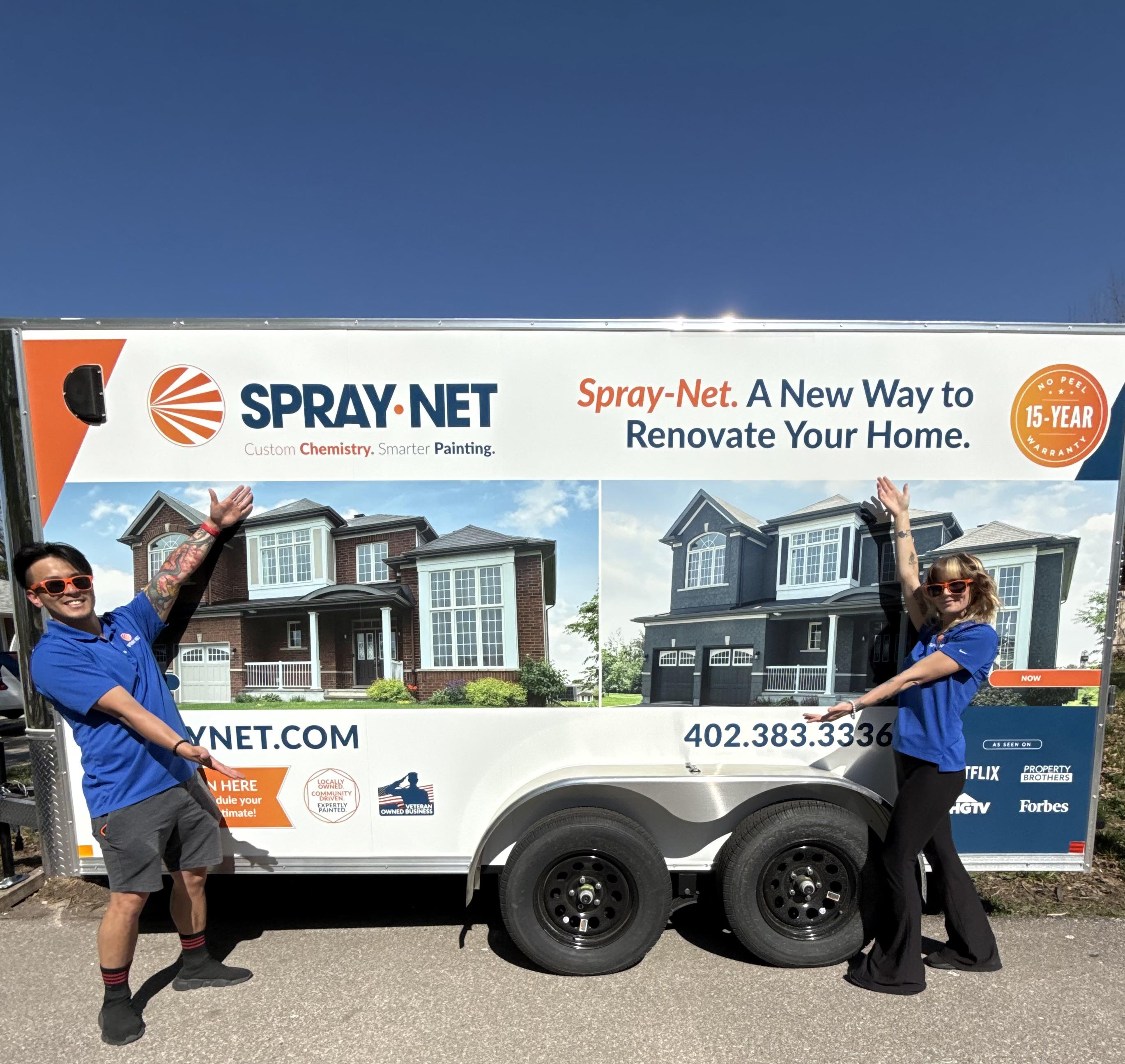 Spray-Net team standing together in front of a company truck.