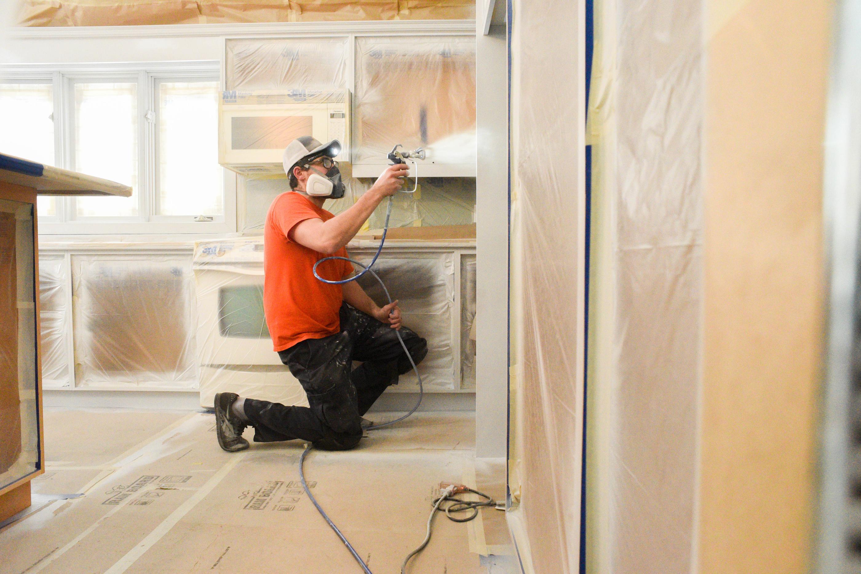 Spraynet employee working on a house
