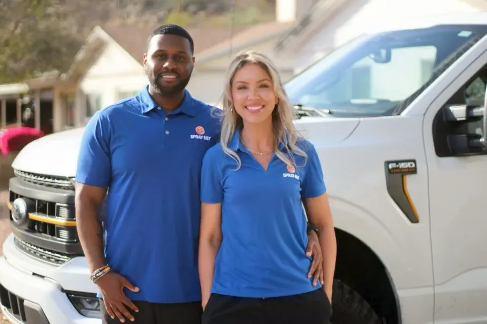 Spray-Net team standing together in front of a company truck.