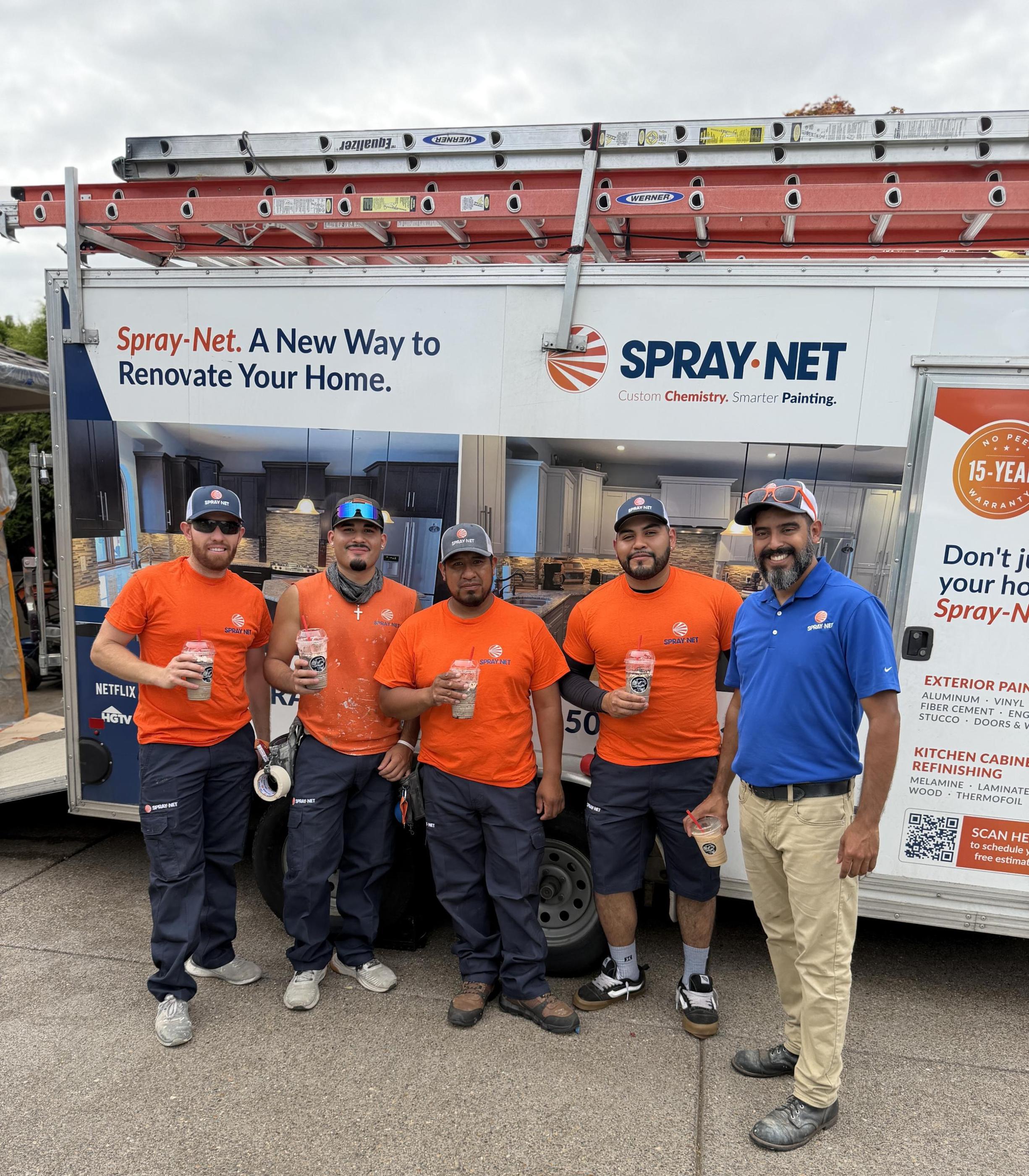 Spray-Net team standing together in front of a company truck.