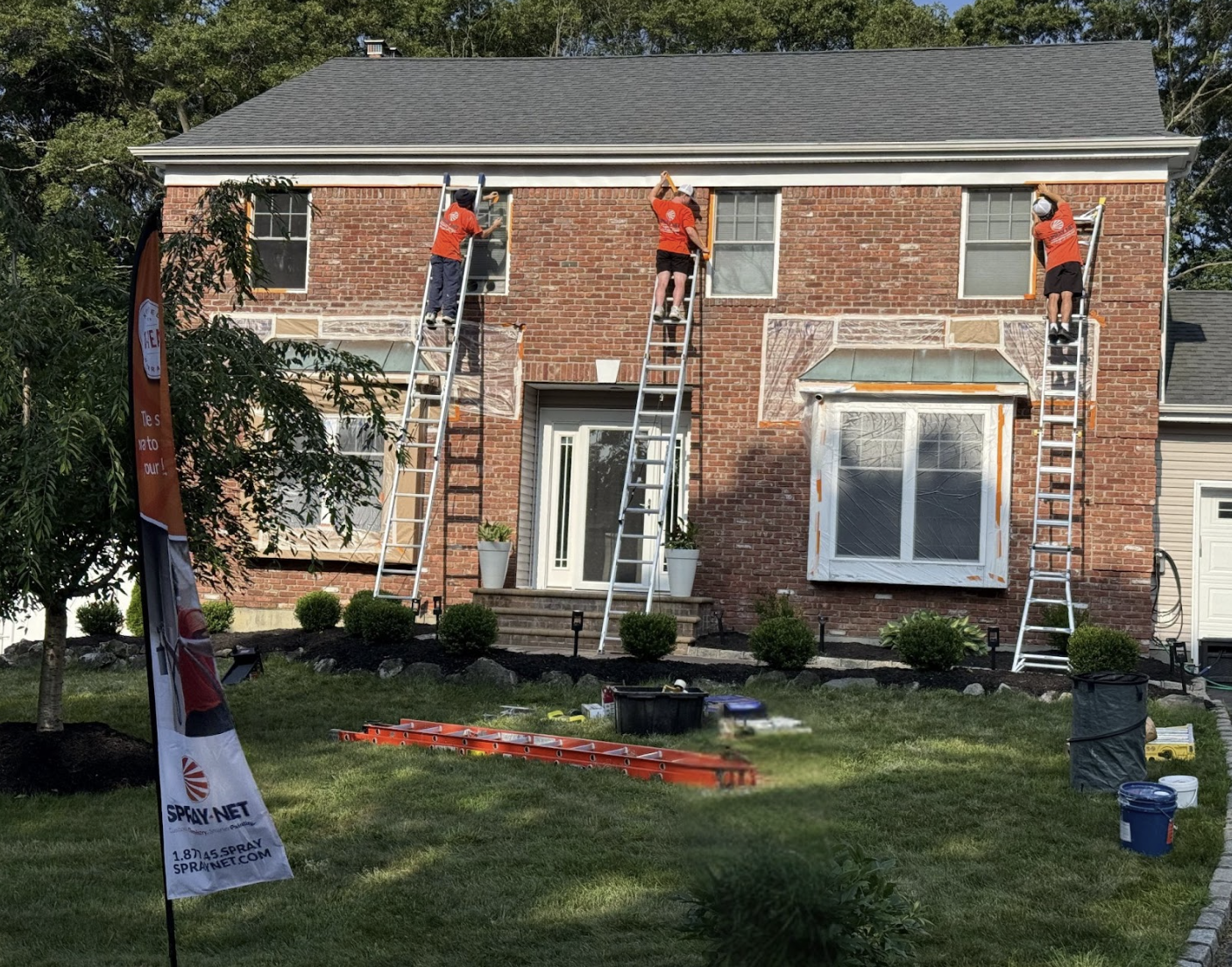 Spray-Net team standing together in front of a company truck.