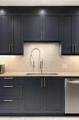 Dark gray kitchen cabinets with gold accents
