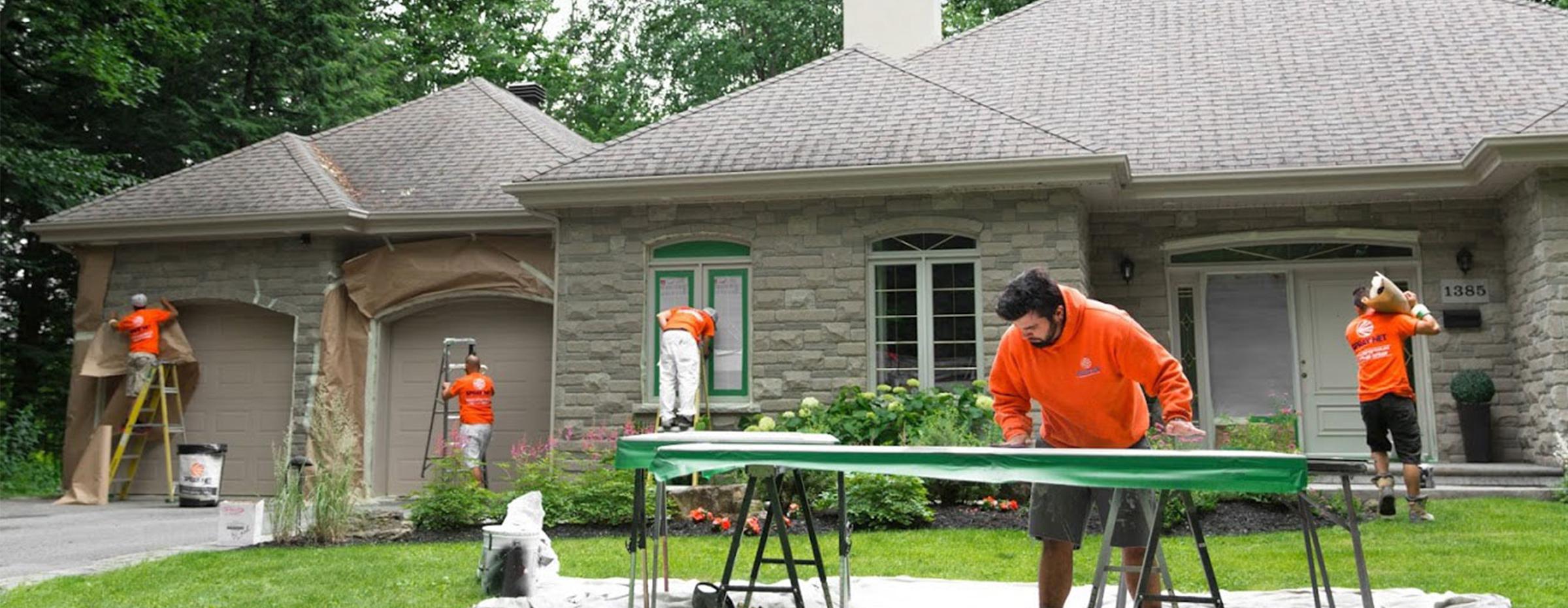 Image of Spray-Net employees prepping house for paint
