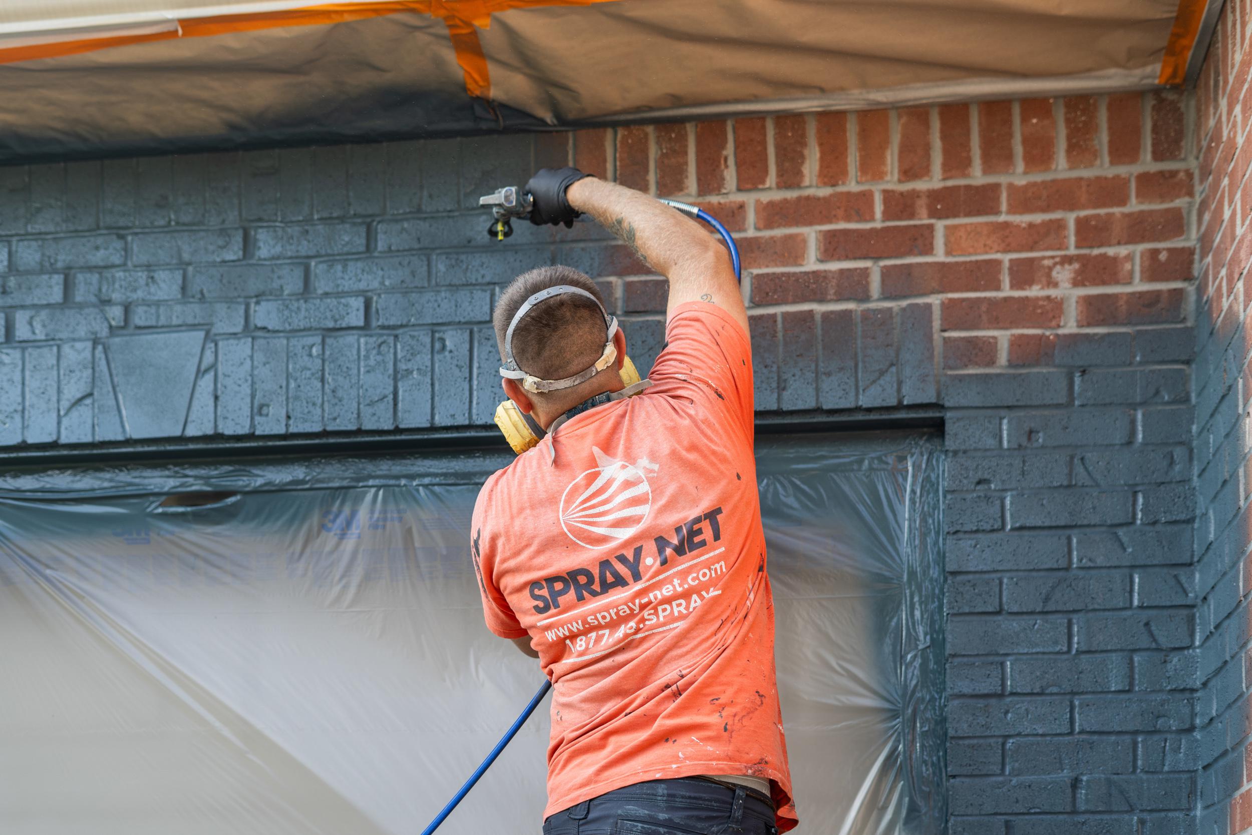 Spraynet employee working on a house